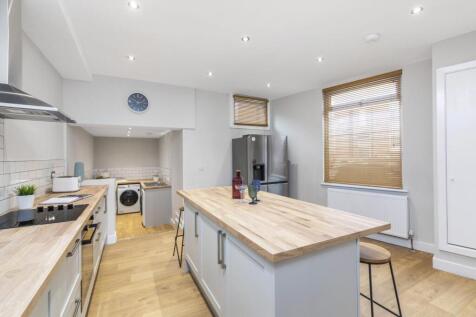 Bright modern kitchen with a central island and...