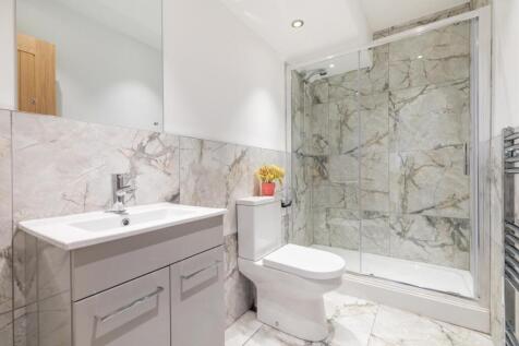 Bright, modern bathroom with a walk-in glass sh...