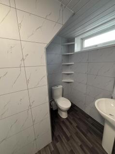 A clean and modern bathroom featuring a toilet ...