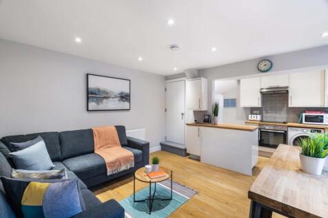 Bright, modern open-plan living area with comfo...