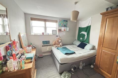 A spacious and inviting master bedroom featurin...