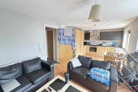 A spacious, modern living room featuring comfor...