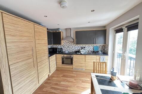 A modern, well-lit kitchen with ample natural l...