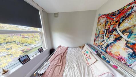 A spacious and well-lit master bedroom featurin...