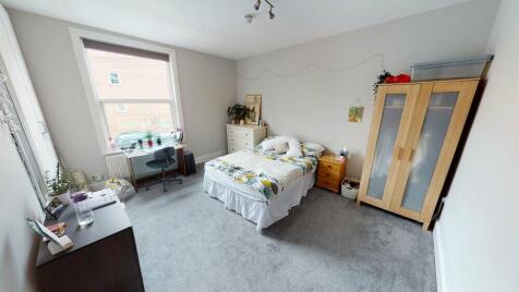 A bright and tidy double bedroom featuring ampl...