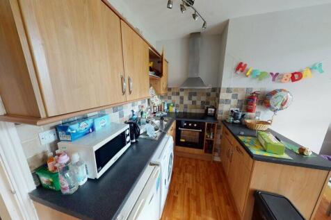 A well-kept kitchen area with ample workspace a...