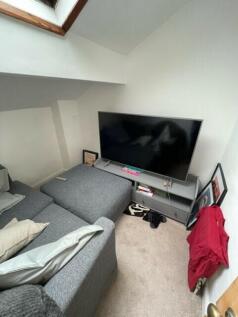 A contemporary living room with a large flat-sc...