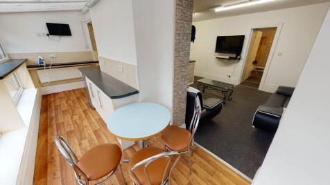 A bright, modern living room featuring ample na...