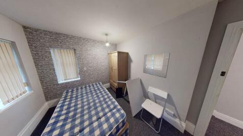 A bright and inviting bedroom featuring a doubl...