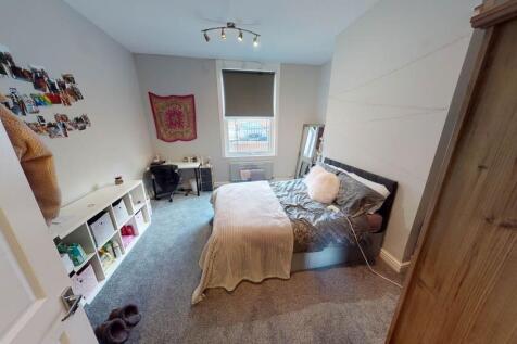 A spacious and inviting master bedroom featurin...