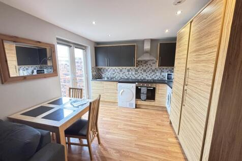 A bright and modern living room featuring ample...