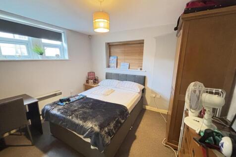 A neatly maintained bedroom featuring a double ...