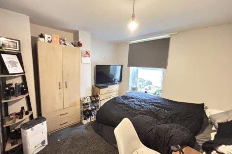 A well-maintained bedroom featuring a comfortab...