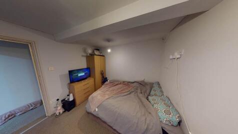 A cozy bedroom with a double bed topped with a ...