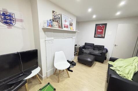 A modern, well-lit living room featuring a comf...