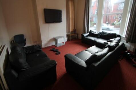 Spacious communal living room with multiple com...