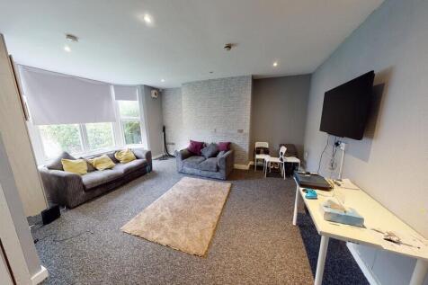 A spacious and well-lit contemporary living roo...