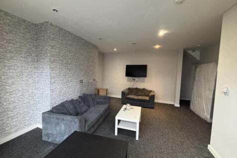 A spacious and modern living room featuring com...