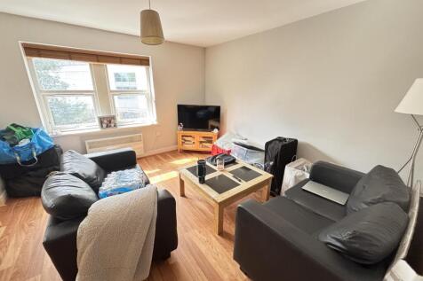 A bright and welcoming living room featuring co...