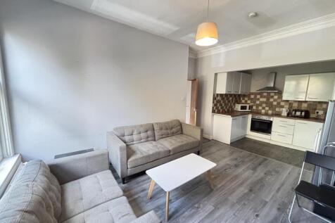 A modern, well-lit living room with comfortable...