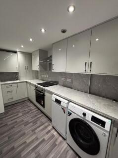 Modern, well-maintained kitchen with sleek whit...