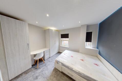 A bright and modern bedroom featuring a large b...