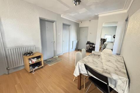 A spacious and well-lit living room featuring c...