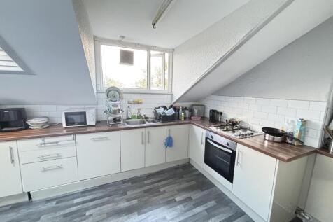 A modern kitchen with ample natural light, clea...