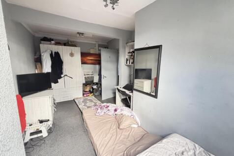 A cozy bedroom with a single bed and minimal cl...