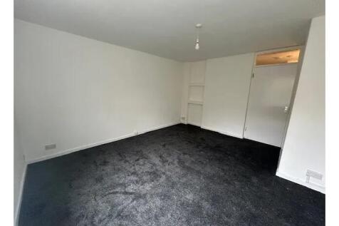 Bright, neutrally decorated living room with fr...