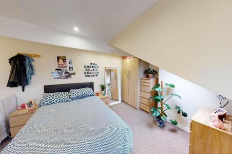 A bright and well-maintained bedroom featuring ...
