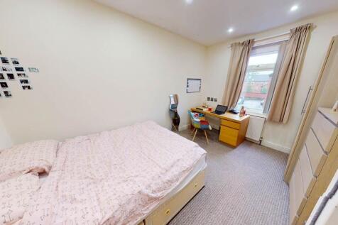 Bright and welcoming double bedroom featuring a...