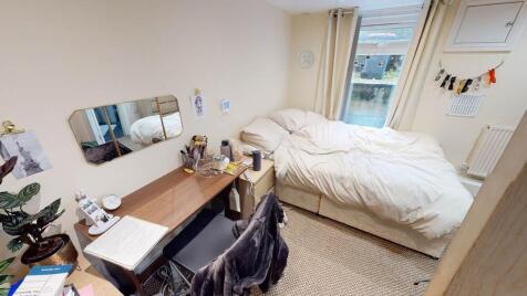 A cozy and well-lit double bedroom featuring a ...