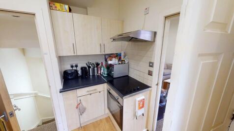 A compact, well-maintained kitchen area featuri...