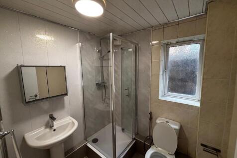 A clean and functional bathroom with a shower e...