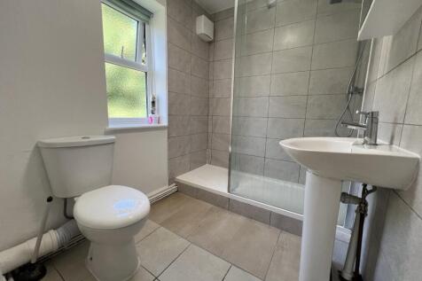 Bright and clean bathroom featuring a toilet, s...
