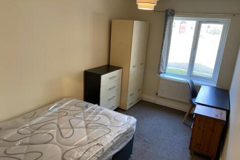 Bright furnished bedroom with a double bed, war...