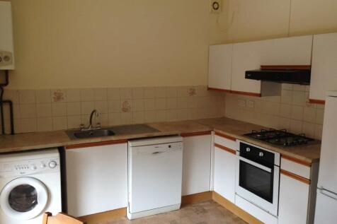 A functional kitchen area featuring a sink, dis...