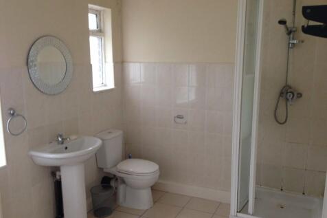 A bright, functional bathroom featuring a showe...