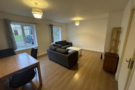 Bright and spacious living room with large wind...