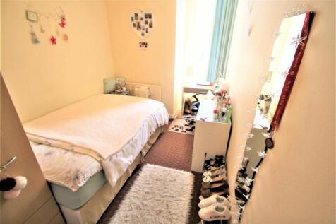 A well-lit, cozy double bedroom featuring a lar...