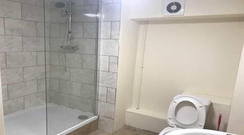 Modern and clean bathroom with a shower enclosu...