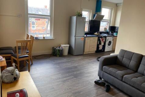 A spacious living area featuring large windows ...