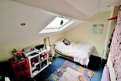 A cozy bedroom illuminated by natural light fro...