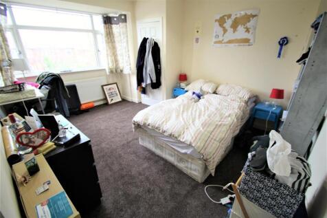 A cozy student bedroom featuring a double bed w...