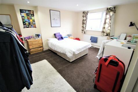 A bright, well-maintained bedroom featuring a c...