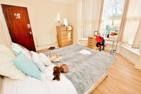 Bright and welcoming double bedroom featuring a...