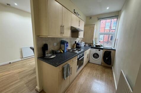 A well-lit kitchen with natural light coming th...