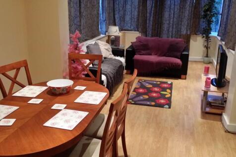 A spacious and inviting living room featuring a...