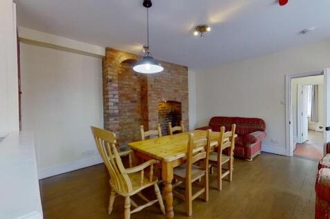 Bright shared living and dining area with a lar...